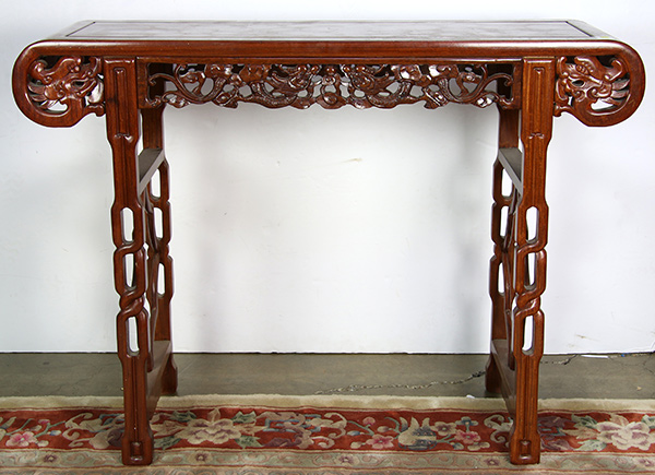 Chinese hardwood altar table, the apron pierced pierced with dragons, raised on braided supports,