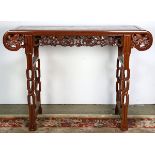 Chinese hardwood altar table, the apron pierced pierced with dragons, raised on braided supports,