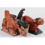 (lot of 2) Balinese polychrome wooden mythical beasts, both of red hue with black and gilt