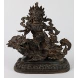 Sino-Tibetan patinated bronze Buddhist figure, of Kubera holding a mongoose and pearl seated on a