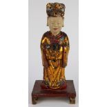 Chinese polychrome wood figure, the celestial official in formal attire with hands clasped to the