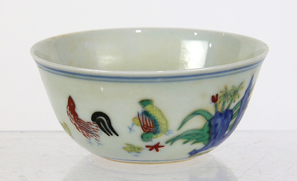 Chinese wucai porcelain cup, decorated with rooster, hen and chicks amid flowers and garden rocks,