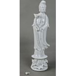 Chinese blanc de chine porcelain bodhisattva, holding a lotus sprig and standing on a pedestal