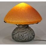 Art Nouveau "Tiffany" style lamp, having a domed glass shade executed in amber, above the bulbous