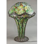 Tiffany style mosaic and leaded glass table lamp, having a domed shade with spider web accents,