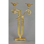 Moderne gilt bronze candelabra, having two lights rising on a geometric standard terminating on a