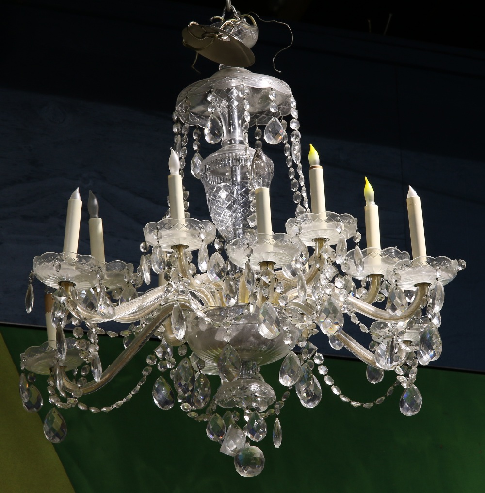 Italian crystal chandelier, the twelve light fixture having a tiered form with contoured supports