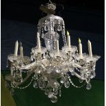 Italian crystal chandelier, the twelve light fixture having a tiered form with contoured supports