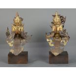 Pair of Thai mirror inlaid wood and metal Garuda, the figure with a jewel in its beak and hands