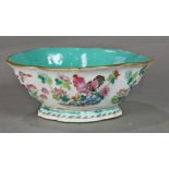 Chinese enameled porcelain footed bowl, with a foliate rim and decorated with roosters amid flowers,