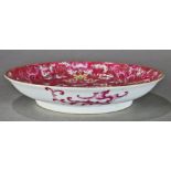 Chinese enameled porcelain plate, with pink and blue dragons on a pink ground with colored clouds,