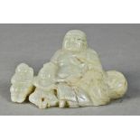Chinese serpentine figural carving, of a Budai seated beside two children and with a treasure