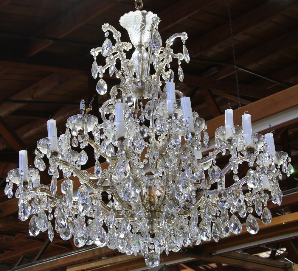 Continental crystal chandelier, the tiered form having eighteen lights, suspended from the gilt