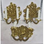 (lot of 3) Gilt two light wall sconces, having a floral wall mount suspending the two light