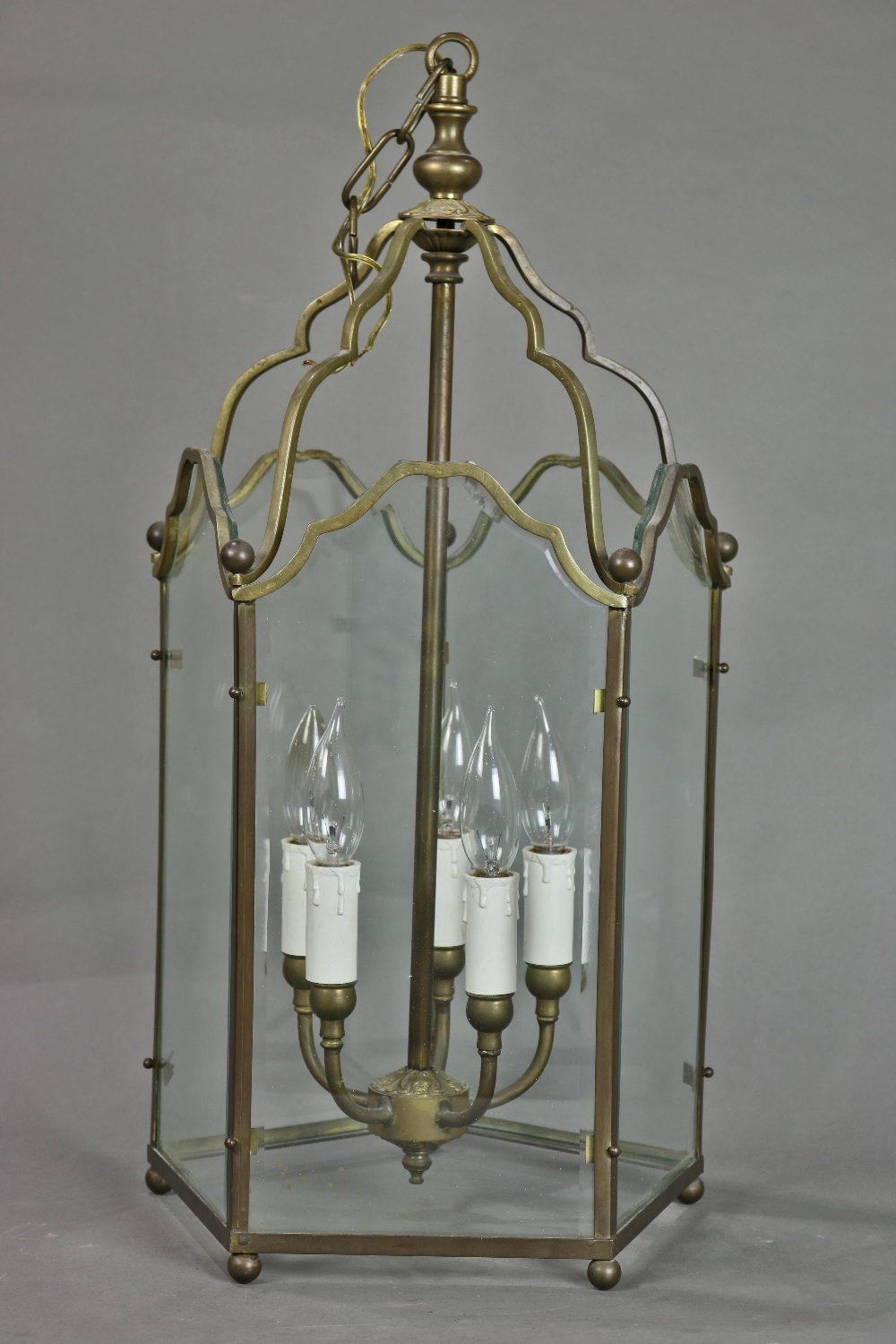 Georgian style brass lantern, having beveled glass panels surrounding five lights