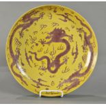 Chines yellow ground porcelain charger, featuring meandering aubergine dragons amid jewels and