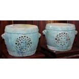 Pair of Chinese green glazed ceramic stools, with openwork dragon roundels and lion form handles,