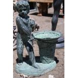 Patinated bronze figural sculpture, depicting a boy pulling a basket and rising on a naturalistic