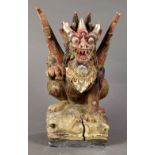 Indonesian polychrome wood figure of Garuda, a winged mythical beast on a plinth, 14.25"h