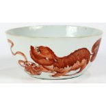 Chinese coral-red enameled porcelain bowl, featuring three fu-lions playing brocade ball, the