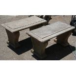 Pair of cast concrete garden benches, each having a bevelled seat above the shaped supports, 17"h