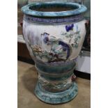 Chinese glazed ceramic fish bowl on stand, the vessel molded with a river landscape scene, raised on