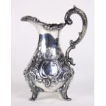 English William Hunter sterling silver cream pitcher, London 1884, having embossed, chased and