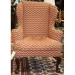 Chippendale-style wing back chair, having carved knees rising on cabriole legs terminating in two