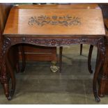 Provincial-style oak slant front desk, having an incised floral decoration on slant front, opening