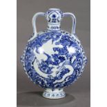 Chinese underglaze blue porcelain moon flask, decorated with blue waves and dragons reserved in