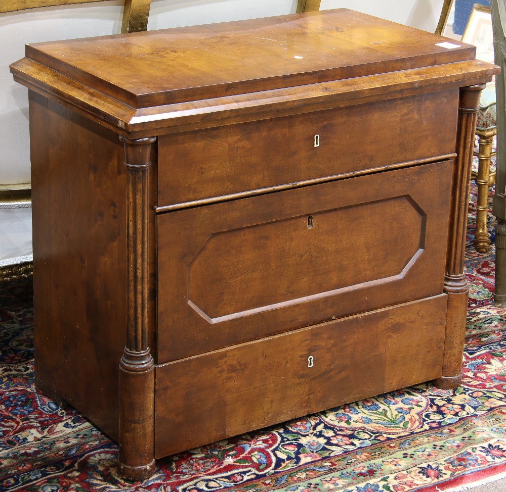 Austrian chest circa 1850, having a casket form top, above the three drawer case, flanked with