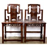 Pair of Chinese wooden side chairs, the stepped back inset with a panel carved with peaches, the