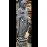 Chinese sculpture of a monk, in abhaya and varda mudra, standing on a pedestal, 59"h