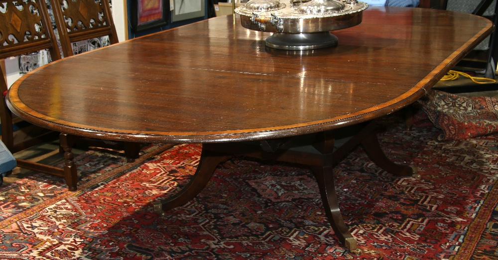 English George III style mahogany dining table, having a circular top with inlaid banding, two 24"
