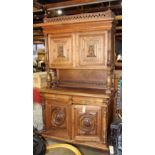 Henry II style oak buffet, circa 1880, having a pierced top flanked with turned finials, above the