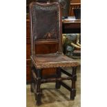 Pair of Continental hallchairs, 18th century, each with a shaped crestrail over a brown leather back