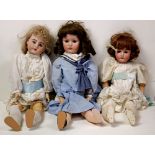 (lot of 5) Porcelain bisque head doll group, each with composite articulated bodies, glass eyes,