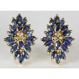 Pair of sapphire, diamond and 14k yellow gold earrings featuring (36) marquise-cut sapphires,