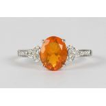 Fire opal, diamond and 14k white gold ring centering (1) oval-cut fire opal, weighing