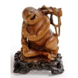 Chinese boxwood carving, featuring Budai with a jewel in one hand and a staff hanging with a