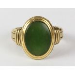 Nephrite and 14K yellow gold ring featuring (1) oval nephrite cabochon, measuring approximately 15 x