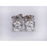 Pair of diamond and 14k white gold stud earrings