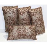 (lot of 4) Group of Fortuny upholstered throw pillows, each having floral decoration on a brown