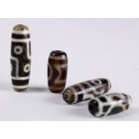 (lot of 4) Chinese/Tibetan dzi type beads, of various patterns on a dark brown ground, 1.25"h