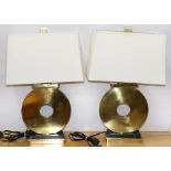 (lot of 2) Robert Abbey brass table lamps, each in the form of a tic-tac-toe "O", and rising on a