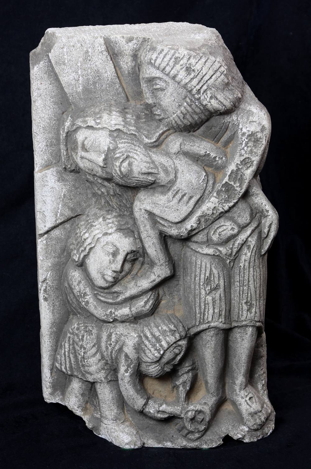 Religious stone figural fragment, depicting Christ in anguish being held by another male figure with