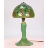 Lundberg Studios irridescent art glass table lamp, the dome shade having pulled feather accents in