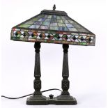 Arts and Crafts style leaded glass student lamp, having a rectangular shade, above a single light,