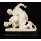 Composition molded figural group, modeled as two men wrestling, rising on a shaped base, signed "