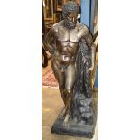 Classical style figural bronze sculpture of a nude male, depicted gazing downward and rising on a